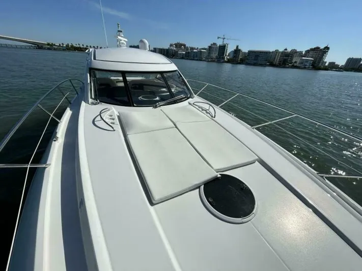 Yacht Photos Pics 2003 Sunseeker 50 Camargue yacht on calm waters with cityscape background.
