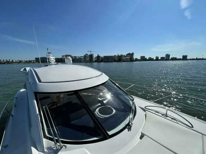  Yacht Photos Pics 2003 Sunseeker 50 Camargue yacht on water with city skyline in background.