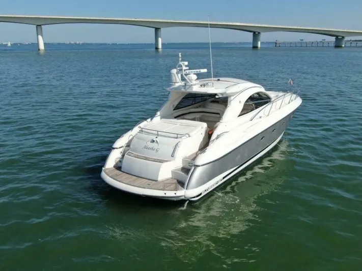  Yacht Photos Pics 2003 Sunseeker 50 Camargue yacht cruising under a bridge on calm waters.