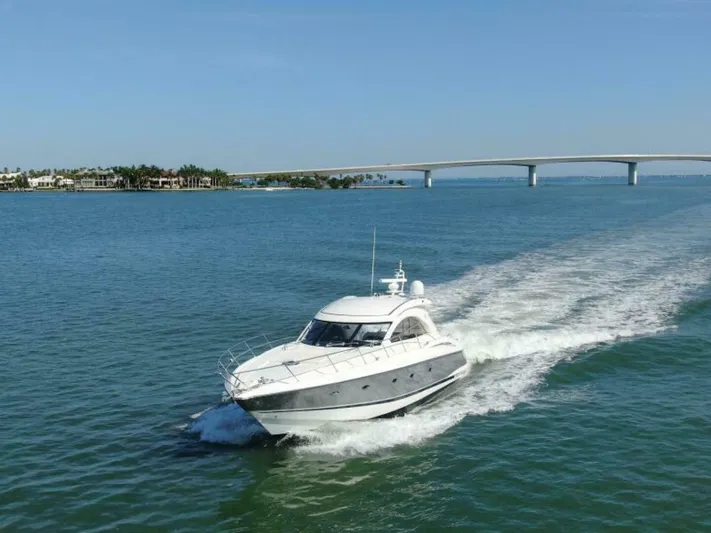  Yacht Photos Pics 2003 Sunseeker 50 Camargue yacht cruising on open water near a bridge.