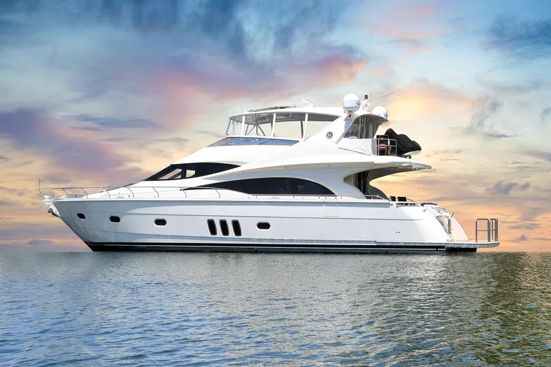 Tuff Ship Yacht Photos Pics Luxury 2007 Marquis 65 yacht on serene water at sunset.