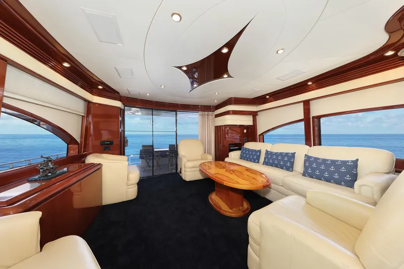 Tuff Ship Yacht Photos Pics Luxurious interior of a 2007 Marquis 65 yacht with elegant seating and ocean view.