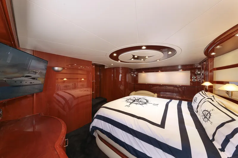 Tuff Ship Yacht Photos Pics Luxurious 2007 Marquis 65 yacht bedroom with elegant wood paneling and nautical-themed bedding.