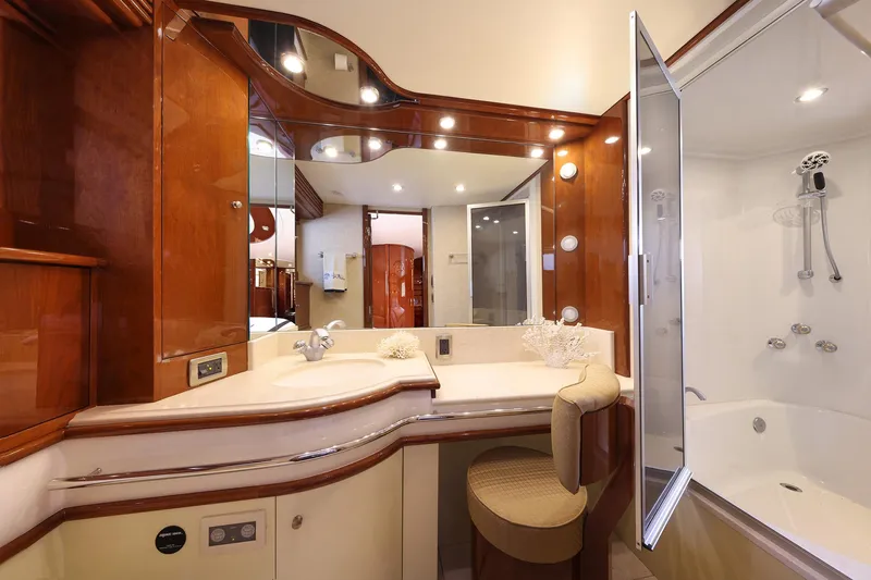 Tuff Ship Yacht Photos Pics Luxurious bathroom interior of 2007 Marquis 65 yacht with elegant wood finishes and modern fixtures.