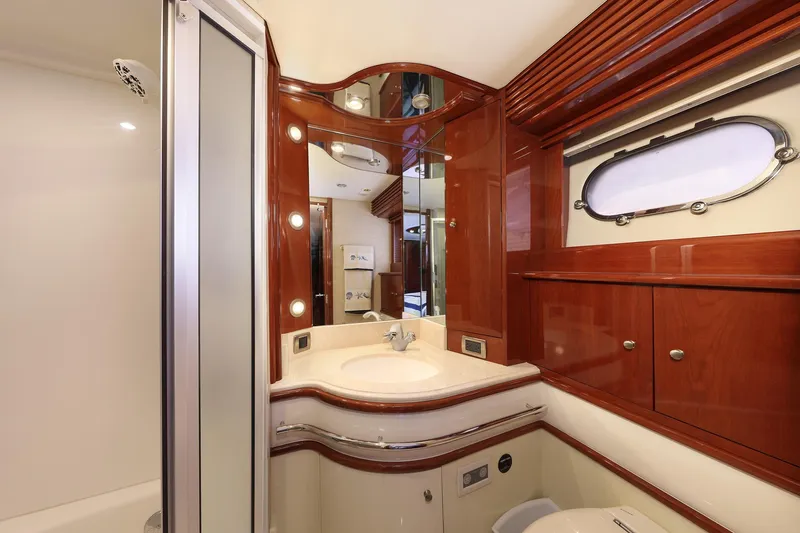 Tuff Ship Yacht Photos Pics Luxurious 2007 Marquis 65 yacht bathroom with elegant wood finishes and modern fixtures.