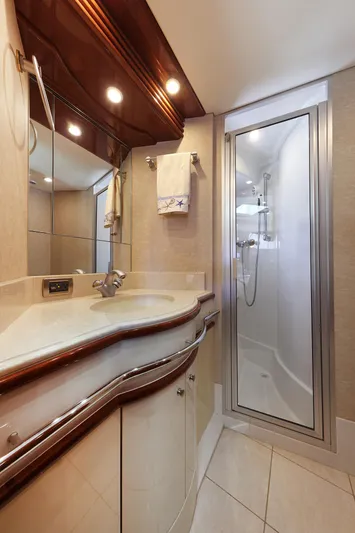 Tuff Ship Yacht Photos Pics Luxurious bathroom in 2007 Marquis 65 yacht with modern fixtures and elegant design.