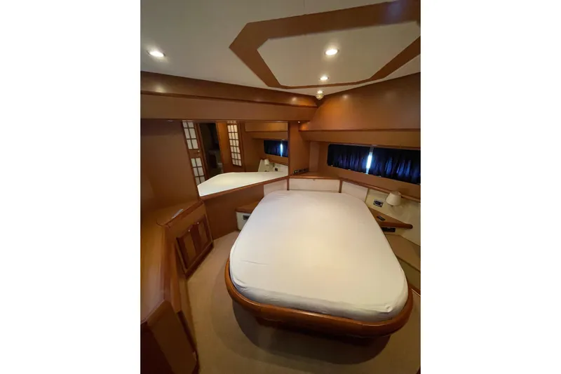  Yacht Photos Pics Luxurious cabin interior of 2008 Mochi Craft Dolphin 44' yacht with elegant wood finish.