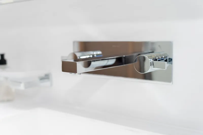 Jewel Yacht Photos Pics Modern chrome faucet on Fountaine Pajot Alegria 2023 yacht bathroom.