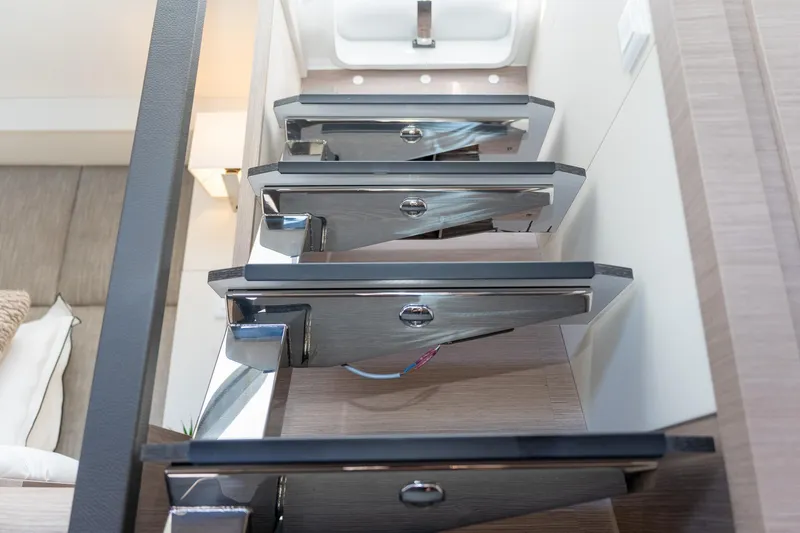 Jewel Yacht Photos Pics Modern staircase inside 2023 Fountaine Pajot Alegria yacht, featuring sleek design and wood accents.