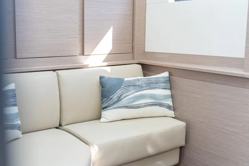 Jewel Yacht Photos Pics 2023 Fountaine Pajot Alegria interior with beige seating and decorative pillows.
