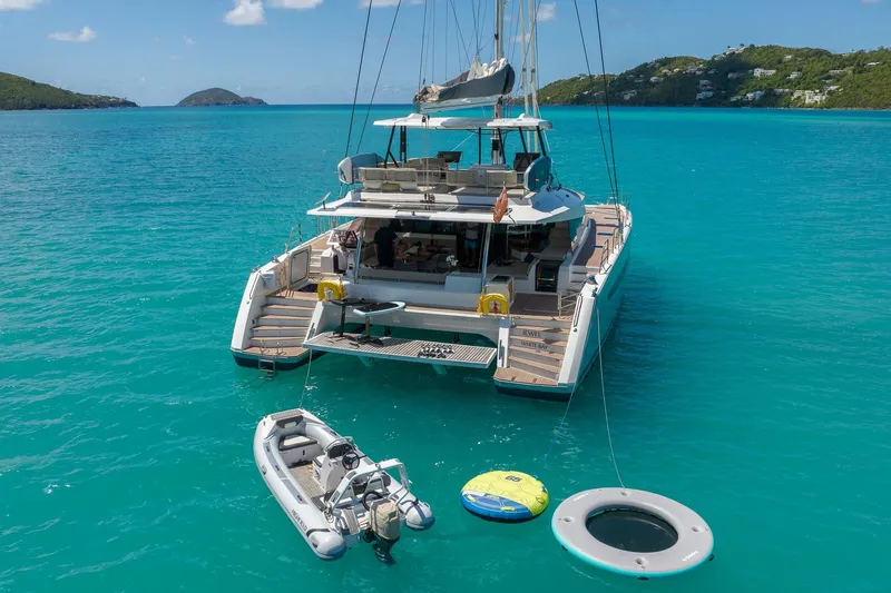 Jewel Yacht Photos Pics 2023 Fountaine Pajot Alegria catamaran anchored in turquoise waters with inflatable toys.