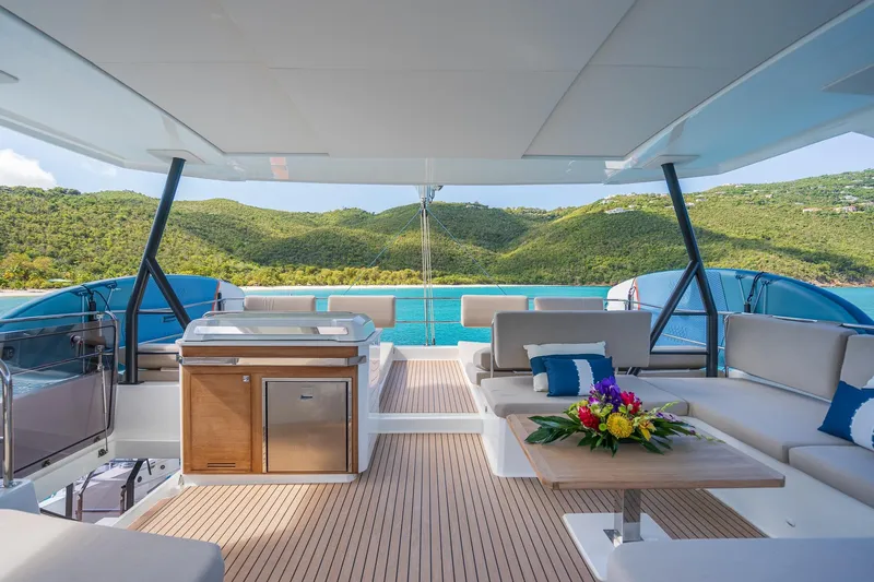 Jewel Yacht Photos Pics Luxurious 2023 Fountaine Pajot Alegria yacht deck with scenic ocean and mountain views.