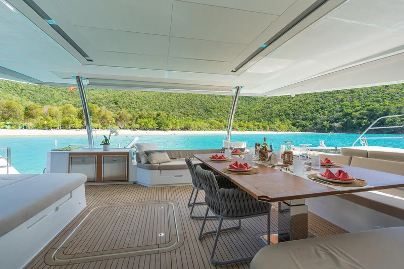 Jewel Yacht Photos Pics Luxurious 2023 Fountaine Pajot Alegria yacht with elegant dining setup and scenic ocean view.