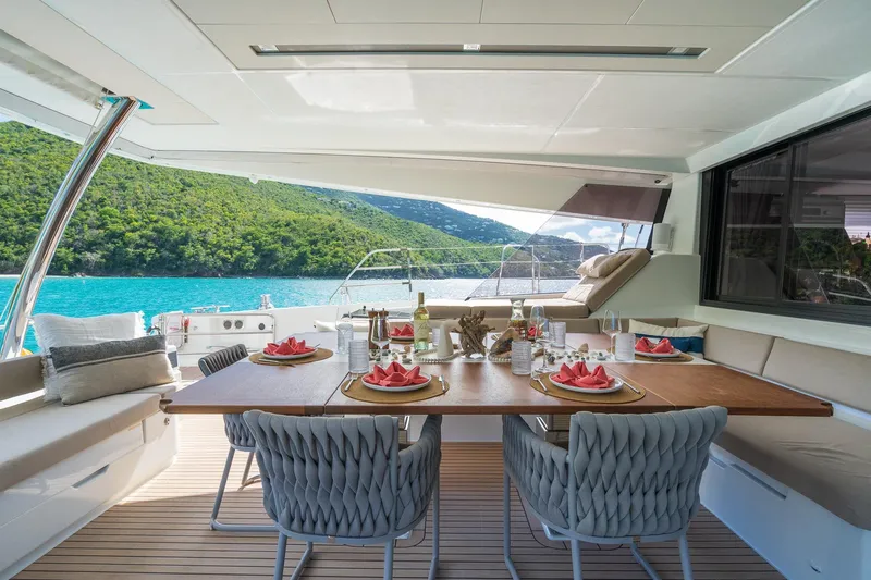 Jewel Yacht Photos Pics Luxurious 2023 Fountaine Pajot Alegria yacht dining area with scenic ocean view.