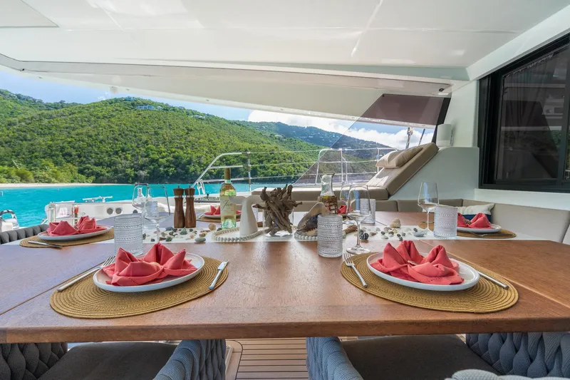 Jewel Yacht Photos Pics Luxurious dining setup on 2023 Fountaine Pajot Alegria yacht with scenic ocean view.