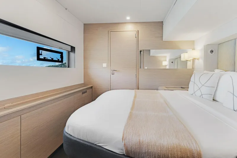 Jewel Yacht Photos Pics Luxurious bedroom interior of 2023 Fountaine Pajot Alegria yacht, featuring modern design and elegant decor.
