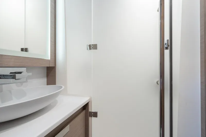 Jewel Yacht Photos Pics Modern bathroom interior on 2023 Fountaine Pajot Alegria yacht, featuring sleek sink and mirror.