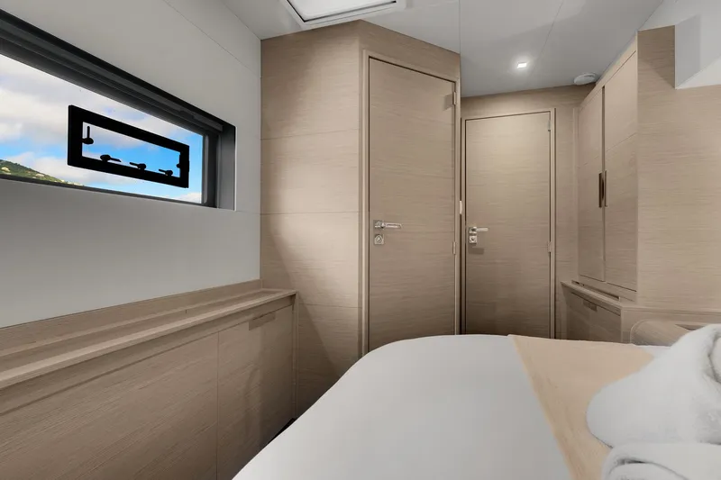 Jewel Yacht Photos Pics Luxurious interior of 2023 Fountaine Pajot Alegria yacht cabin with modern wood finishes.