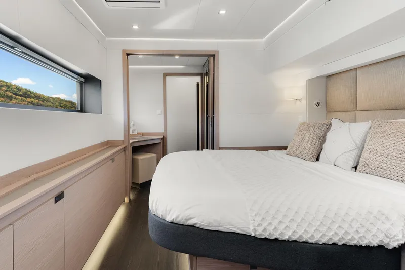 Jewel Yacht Photos Pics Luxurious 2023 Fountaine Pajot Alegria yacht bedroom with modern design and scenic window view.
