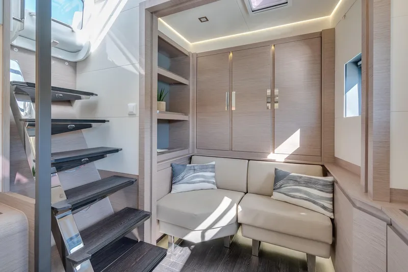 Jewel Yacht Photos Pics Modern interior of 2023 Fountaine Pajot Alegria yacht with cozy seating and sleek staircase.
