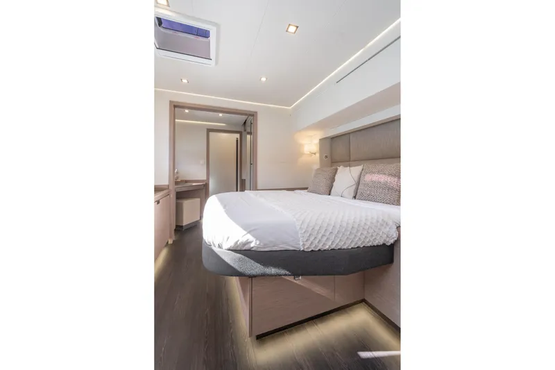 Jewel Yacht Photos Pics Luxurious bedroom interior of 2023 Fountaine Pajot Alegria yacht, featuring modern design and cozy bedding.