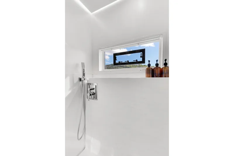 Jewel Yacht Photos Pics Modern shower interior on 2023 Fountaine Pajot Alegria yacht, featuring sleek fixtures and window view.