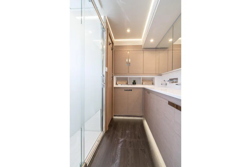 Jewel Yacht Photos Pics Modern bathroom interior on 2023 Fountaine Pajot Alegria yacht, featuring sleek cabinetry and glass shower.