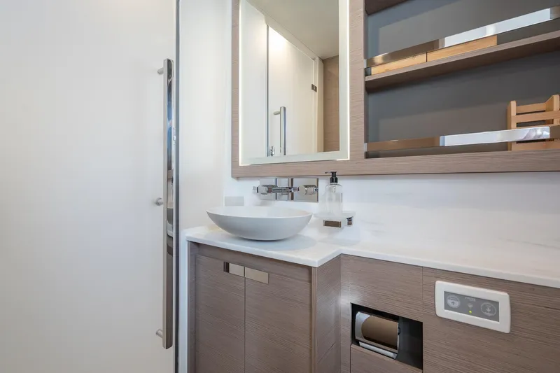 Jewel Yacht Photos Pics Modern bathroom on 2023 Fountaine Pajot Alegria yacht with sleek sink and mirror.