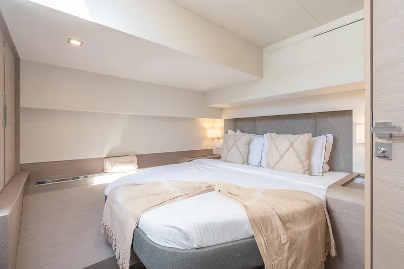 Jewel Yacht Photos Pics Luxurious bedroom interior of 2023 Fountaine Pajot Alegria yacht, featuring elegant bedding and modern design.