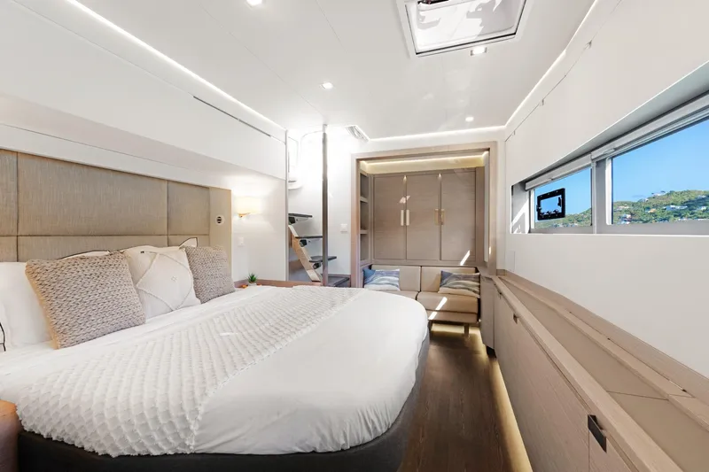 Jewel Yacht Photos Pics Luxurious 2023 Fountaine Pajot Alegria yacht bedroom with modern design and scenic window view.