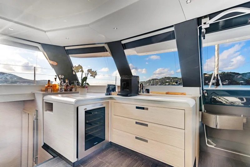 Jewel Yacht Photos Pics Luxurious 2023 Fountaine Pajot Alegria yacht interior with modern kitchen and scenic views.