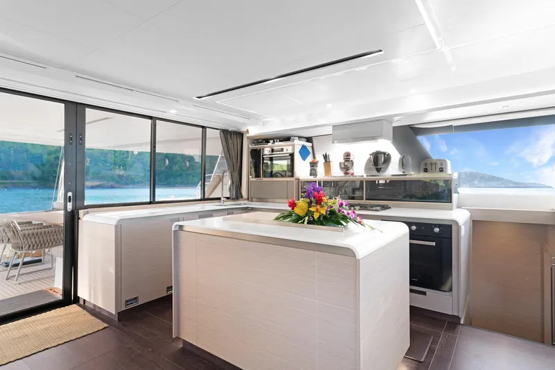 Jewel Yacht Photos Pics Luxurious 2023 Fountaine Pajot Alegria yacht interior with modern kitchen and ocean view.