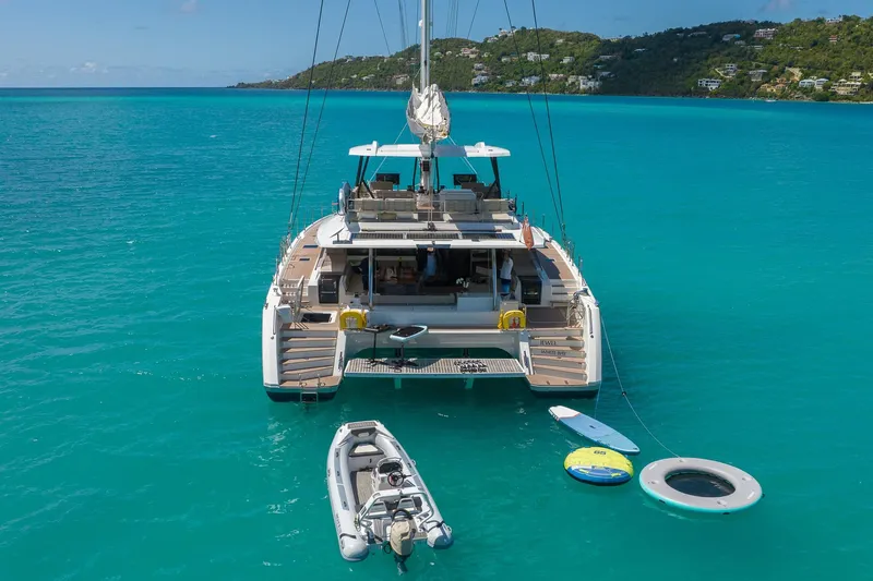 Jewel Yacht Photos Pics 2023 Fountaine Pajot Alegria catamaran anchored in turquoise waters with water toys.