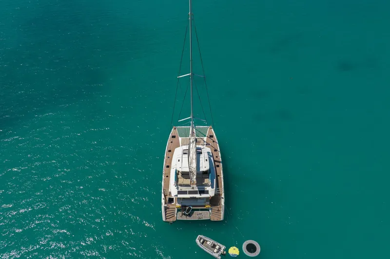 Jewel Yacht Photos Pics Aerial view of 2023 Fountaine Pajot Alegria catamaran on turquoise water.