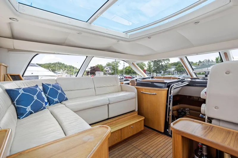 Playpen Yacht Photos Pics Luxurious interior of 2003 Tiara Yachts 5200 Sovran with spacious seating and skylight.