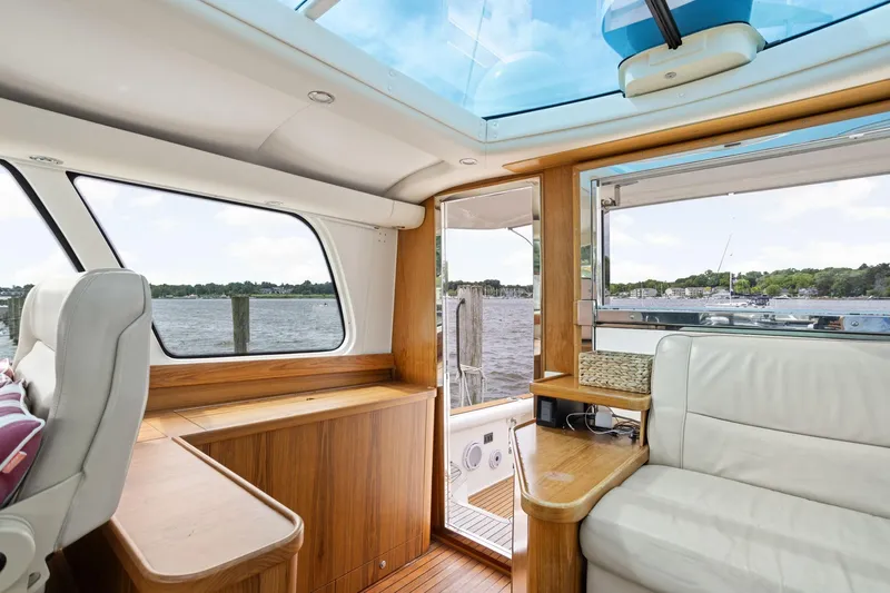 Playpen Yacht Photos Pics Interior of 2003 Tiara Yachts 5200 Sovran with scenic water view through windows.