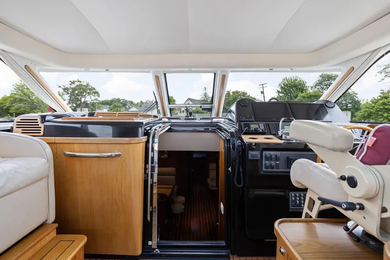 Playpen Yacht Photos Pics Interior of 2003 Tiara Yachts 5200 Sovran, featuring helm and seating area.