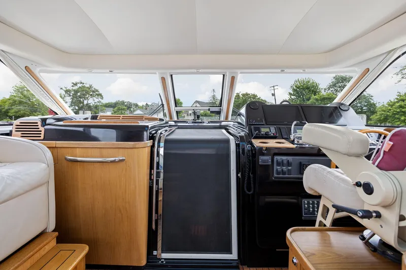 Playpen Yacht Photos Pics Interior of 2003 Tiara Yachts 5200 Sovran, featuring helm and seating area.