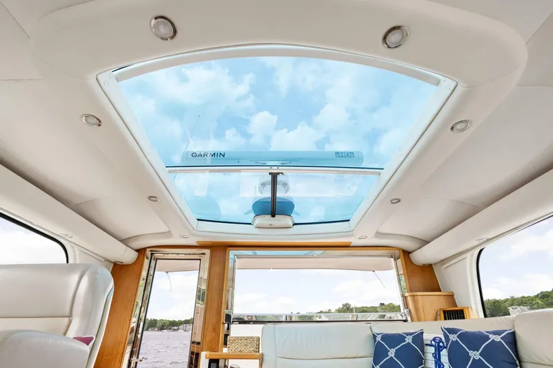 Playpen Yacht Photos Pics Interior view of 2003 Tiara Yachts 5200 Sovran with glass ceiling and plush seating.