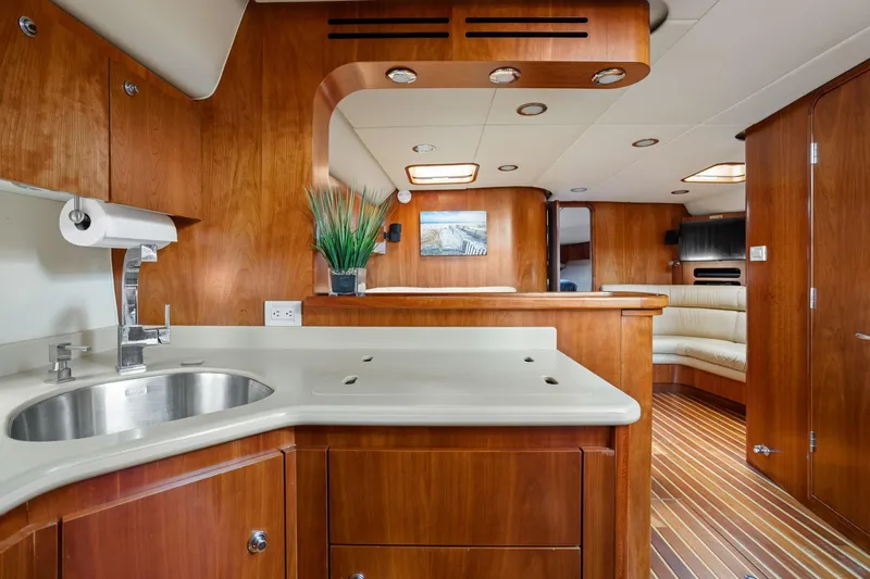 Playpen Yacht Photos Pics Luxurious interior of 2003 Tiara Yachts 5200 Sovran with wood finish and modern amenities.