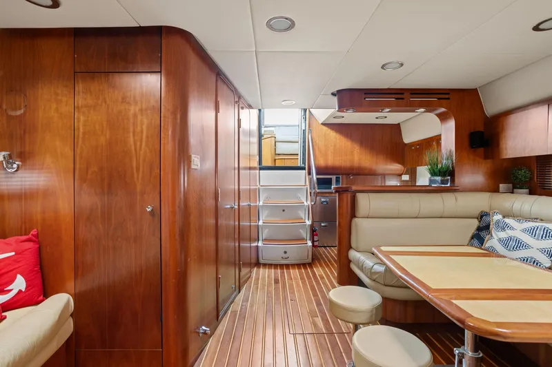 Playpen Yacht Photos Pics Luxurious 2003 Tiara Yachts 5200 Sovran interior with elegant wood finish and cozy seating.