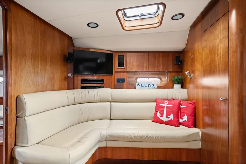 Playpen Yacht Photos Pics Luxurious 2003 Tiara Yachts 5200 Sovran interior with beige seating and nautical decor.