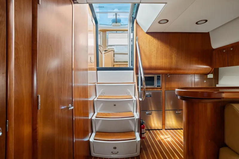 Playpen Yacht Photos Pics Interior of 2003 Tiara Yachts 5200 Sovran with wooden cabinetry and stairs.