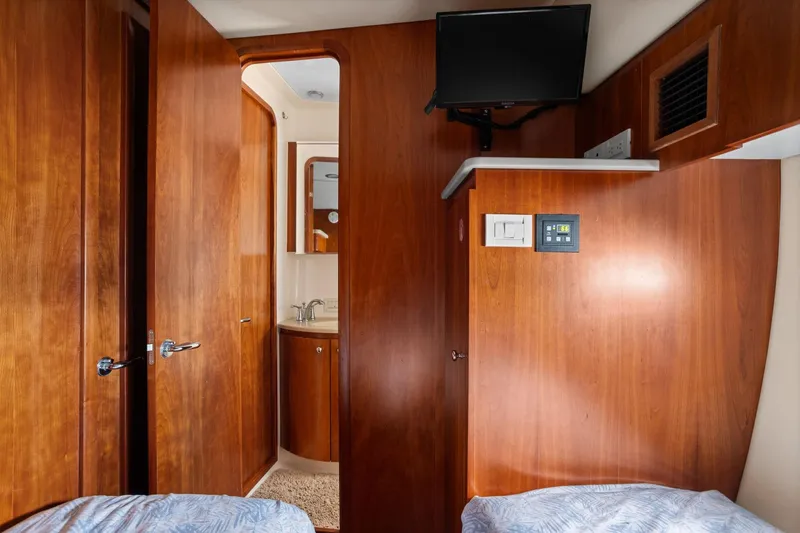 Playpen Yacht Photos Pics 2003 Tiara Yachts 5200 Sovran cabin interior with wood paneling and bathroom view.