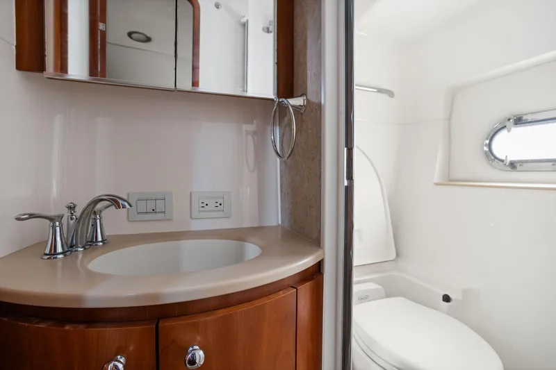 Playpen Yacht Photos Pics Luxurious bathroom in 2003 Tiara Yachts 5200 Sovran with sink and toilet.