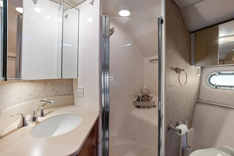 Playpen Yacht Photos Pics Luxurious bathroom in 2003 Tiara Yachts 5200 Sovran with modern fixtures and shower.