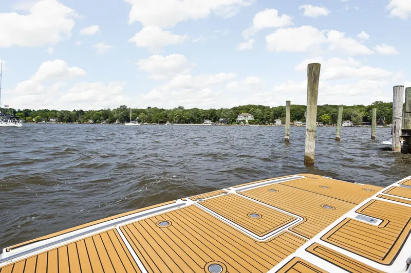 Playpen Yacht Photos Pics 2003 Tiara Yachts 5200 Sovran deck overlooking serene waterfront and docks.