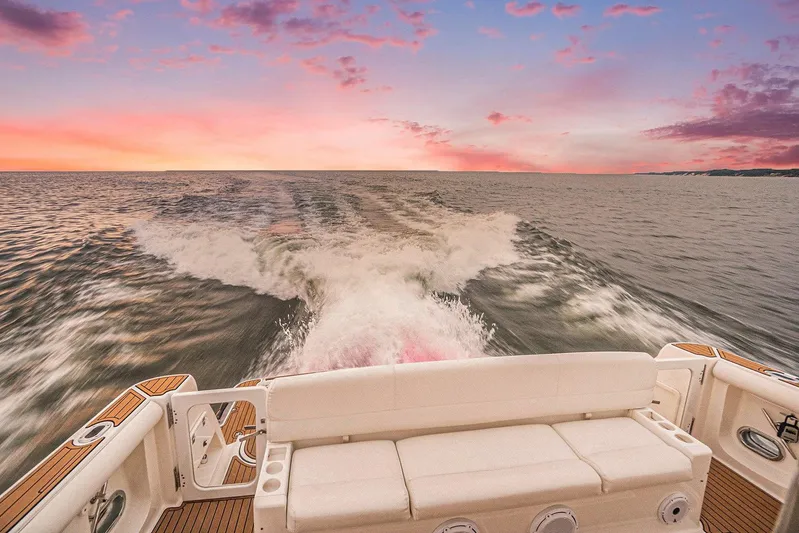 Playpen Yacht Photos Pics Tiara Yachts 5200 Sovran 2003 cruising at sunset, leaving a wake on the ocean.