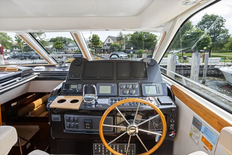 Playpen Yacht Photos Pics Helm of 2003 Tiara Yachts 5200 Sovran with steering wheel and navigation equipment.