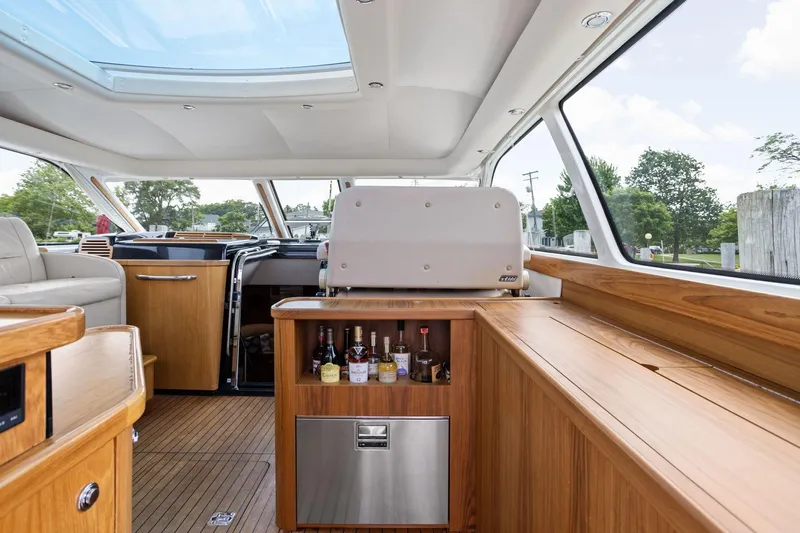 Playpen Yacht Photos Pics Luxurious interior of 2003 Tiara Yachts 5200 Sovran with wooden cabinetry and skylight.